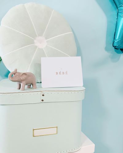 Pastel baby keepsake box, decorative elephant and card reading bébé